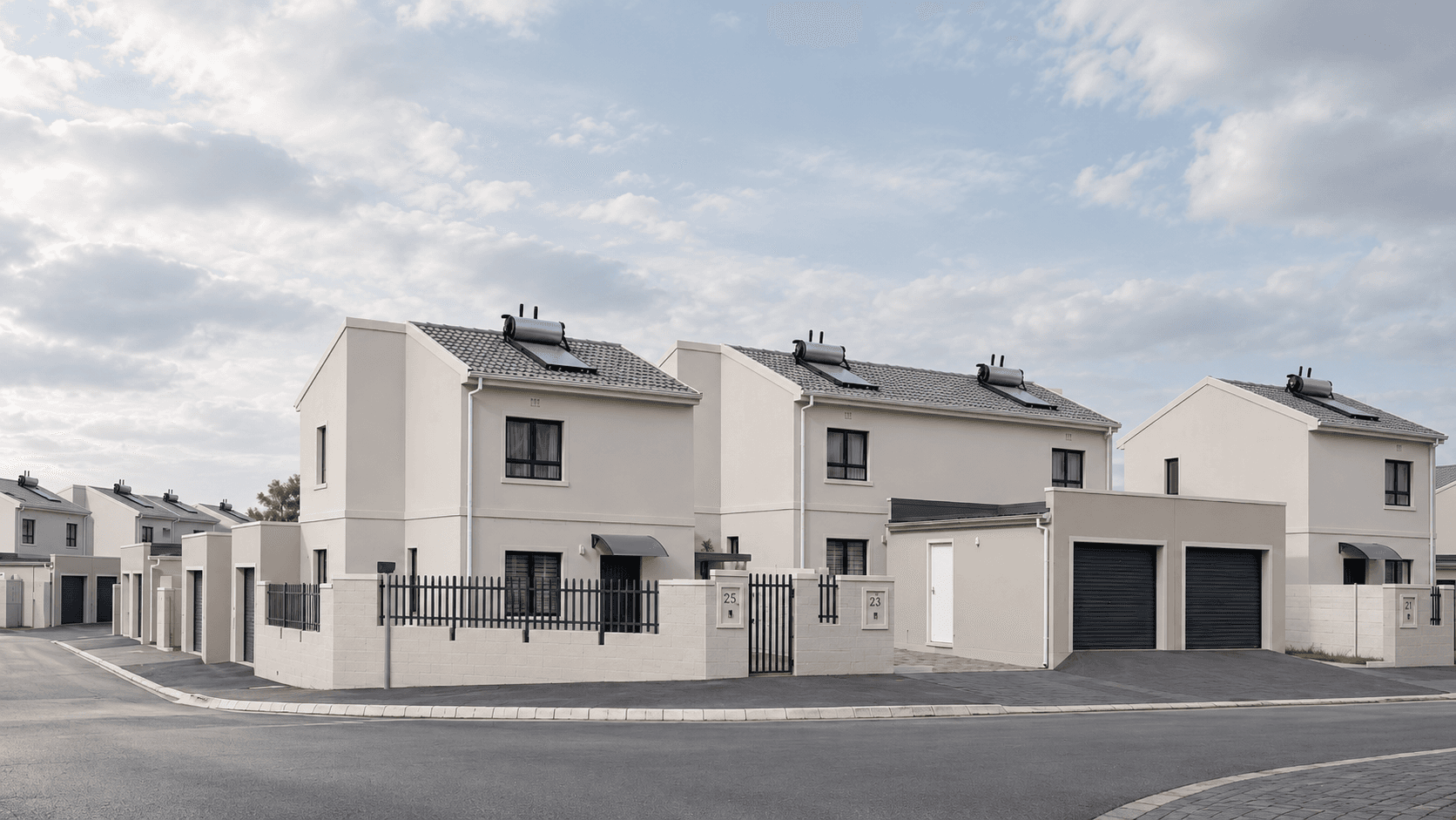 Exterior row of homes with a paved road in the foreground
